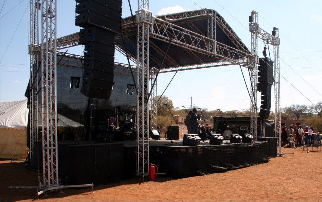 Aluminium trussing stage structure with lighting and sound equipment for outdoor event production and engineering applications.