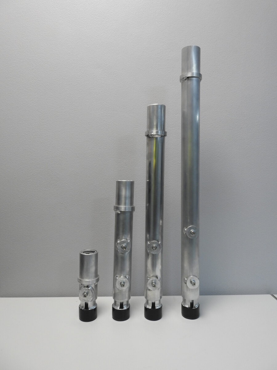 Aluminium trussing vertical support tubes of varying heights with mounting points, used for rigging and structural support in event production setups.