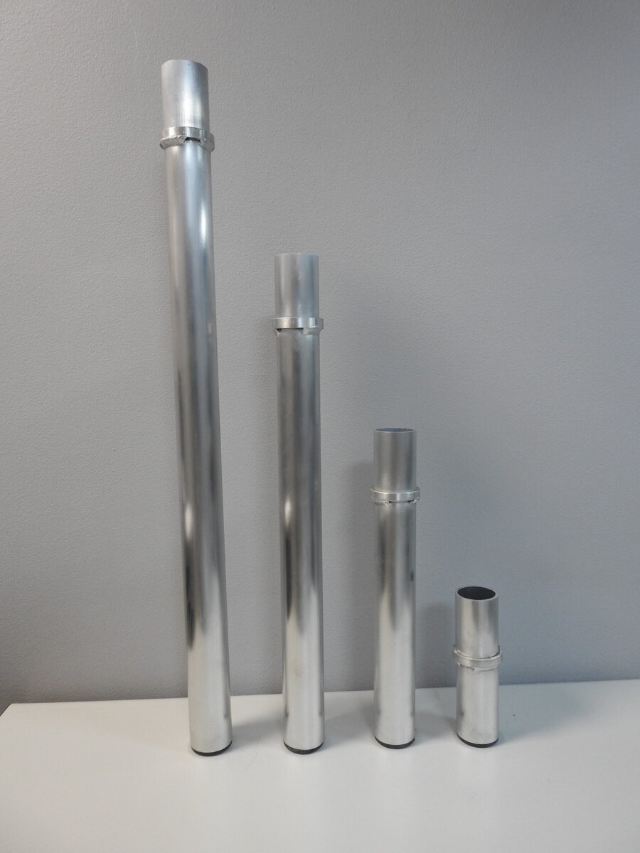 Aluminium trussing tubes of varying lengths, used for structural support in event staging and rigging applications.