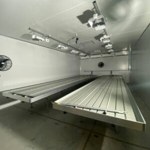 Aluminium trussing stage with lighting fixtures and fans in a professional event production environment.