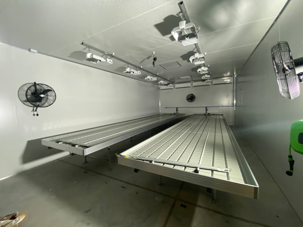 Aluminium trussing stage with lighting fixtures and fans in a professional event production environment.