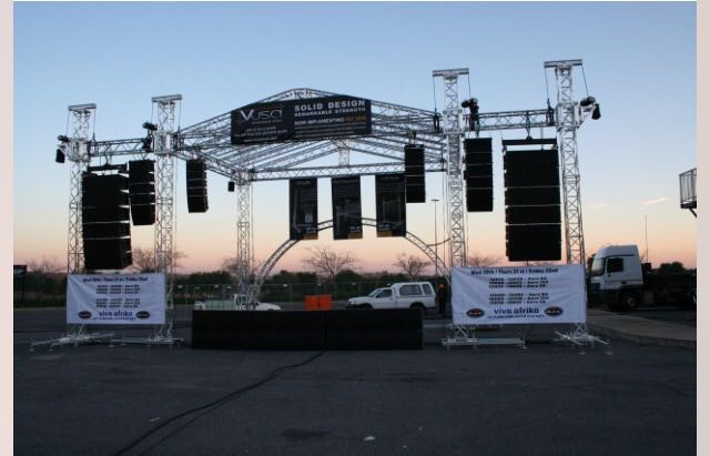 Aluminium trussing stage setup with LED screens and lighting rig for live event production, featuring modular structural components for professional u.